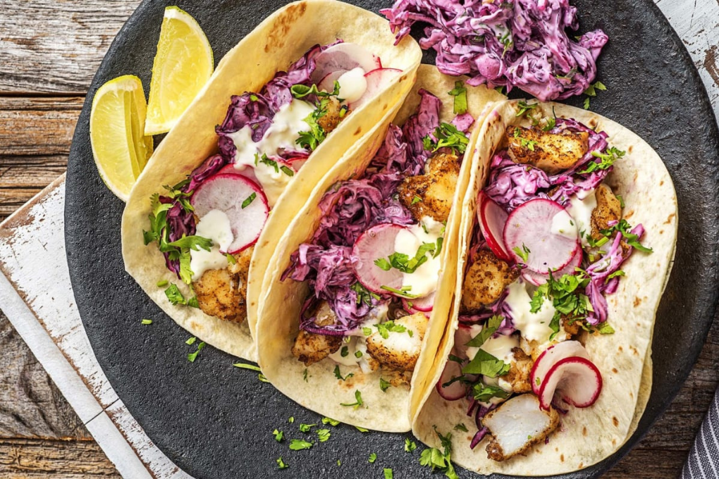 Blackened Fish Tacos with Avocado Lime Crema, Crunchy Red Cabbage Slaw & Charred Corn Salad